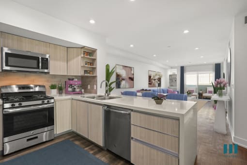 Open-Concept Kitchen with Stainless-Steel Appliances and Countertop Bar