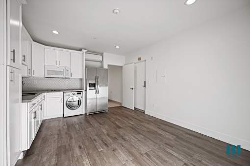 A kitchen with white cabinets and stainless steel appliances.