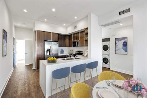 Open-Concept Kitchen with Countertop-Bar, Energy-Efficient Appliances, and In-Suite Washer & Dryer