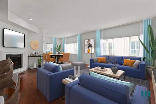 A living room with blue couches and a fireplace.