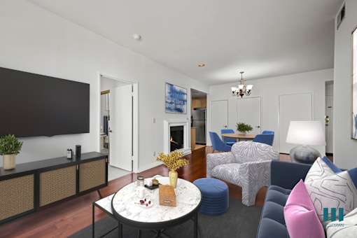 A modern living room with a fireplace and a television.