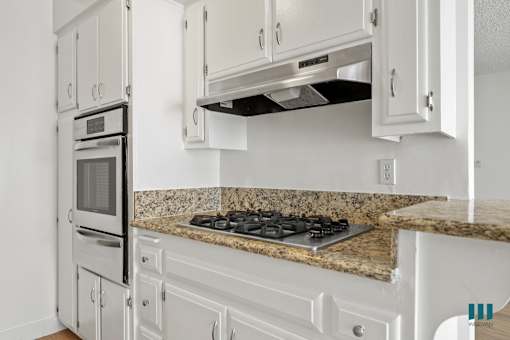 Kitchen with Granite Countertops, Stainless-Steel Stove, and Ample Cabinet Storage