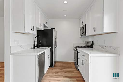 Kitchen with Stainless-Steel Refrigerator, Stove, Dishwasher, and Microwave Oven