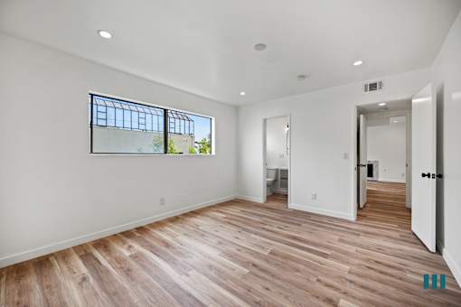 Bedroom with Vinyl Flooring, Recessed Lighting, and Bathroom