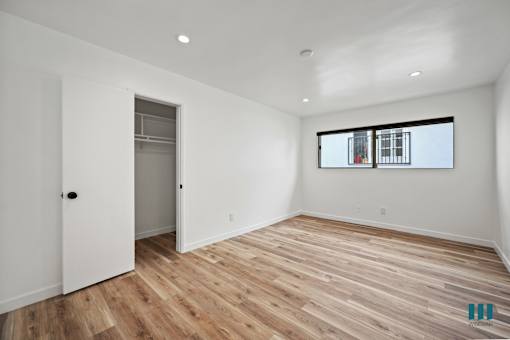 Bedroom with Recessed Lighting, Vinyl Flooring, and a Closet