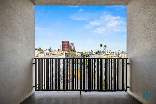 A view from a balcony looking out at a cityscape.