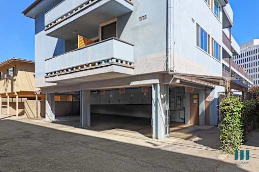 A two-story building with a garage underneath.