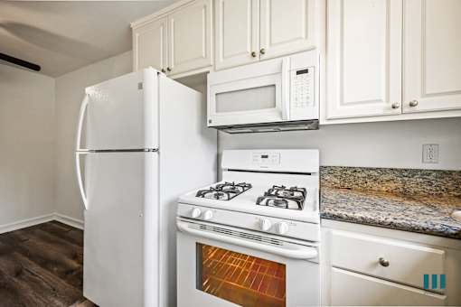 Kitchen with Refrigerator, Stove, and Microwave Oven