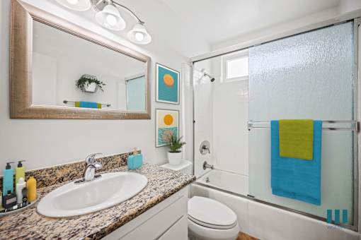 Bathroom with Shower Bath with Glass Door and Vanity Cabinet Storage