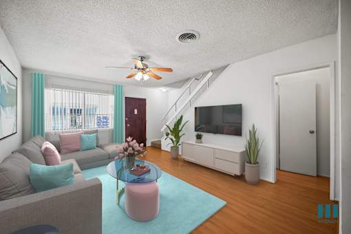 Entryway and Living Room with a Stairwell to the Upper Level of a Townhome