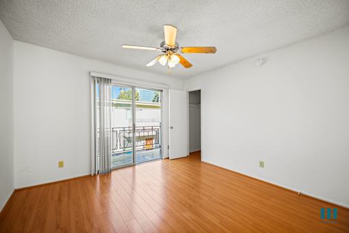 Bedroom with Vinyl Flooring, Ceiling Fan, Closet, and Balcony