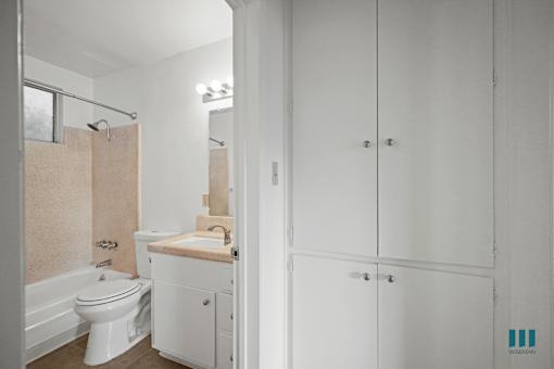 Hall Cabinets and Bathroom with a Shower-Bath and Vanity Cabinet Storage