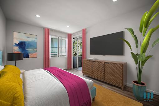 A bedroom with a large bed and a flat screen TV mounted on the wall.