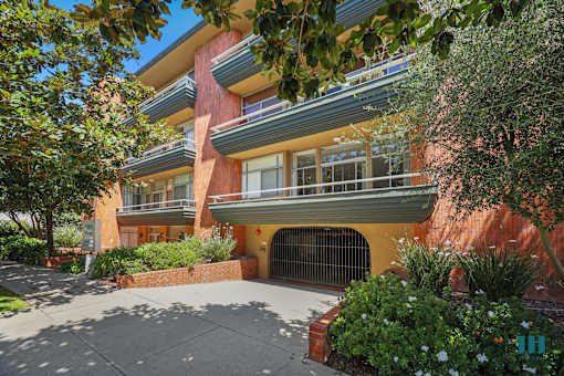 A building with a red brick wall and a balcony.