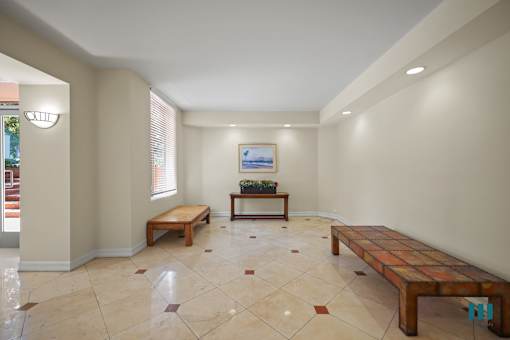 A room with a tiled floor and a painting on the wall.