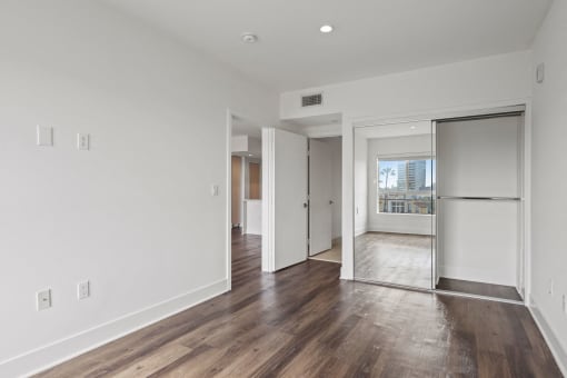 Bedroom with Mirrored Closet, Vinyl Flooring, and Recessed Lighting