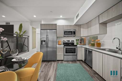 Open-Concept Kitchen with Stainless-StKitchen with Refrigerator, Stove, Microwave Oven, and Dishwasher - Two-Bedroom Two-Bathroom - Unit 108