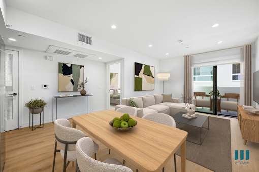 A modern dining room with a wooden table and chairs.