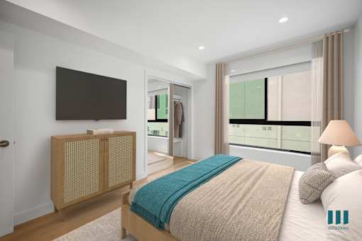 A bedroom with a bed, a TV, and a window with a view of a city.