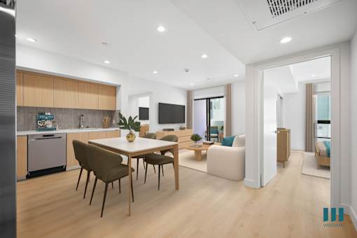 A modern kitchen with a dining table and chairs.