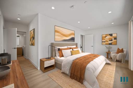 A modern bedroom with a large bed and a painting on the wall.