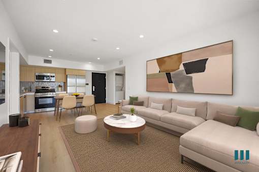 A modern living room with a large abstract painting on the wall.