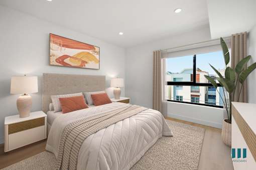 A bedroom with a large bed, two lamps, and a painting on the wall.