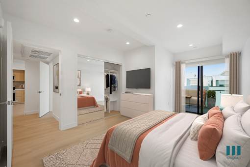 A bedroom with a large bed and a television in the corner.