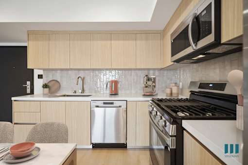 A kitchen with a stove, oven, and microwave.