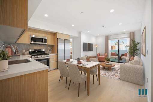 A modern kitchen with a dining table and chairs.