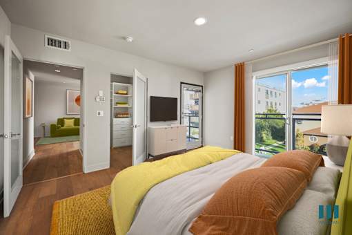 Primary Bedroom with a Balcony, Walk-In Closet with Built-In Organizers, Recessed Lighting, and Vinyl Flooring