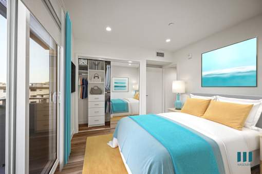 A bedroom with a large bed and a painting of a beach on the wall.