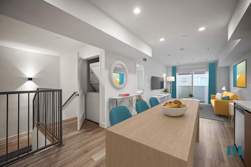 A modern kitchen with a wooden island and blue chairs.