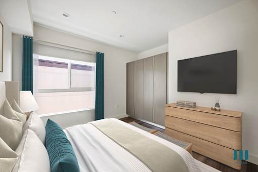 a bedroom with a bed and a tv on the wall