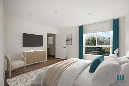 a bedroom with a bed and a tv on the wall