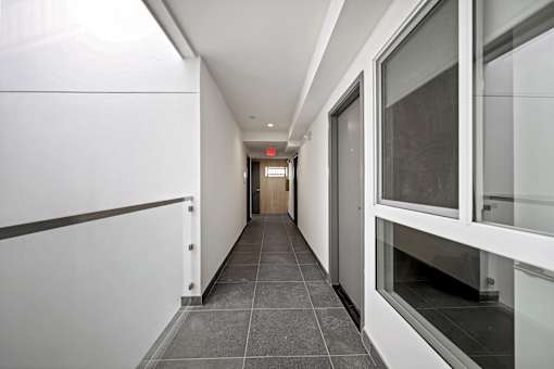 A long hallway with a door at the end.