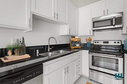 Kitchen with Stainless-Steel Dishwasher, Stove, Microwave Oven, and Refrigerator