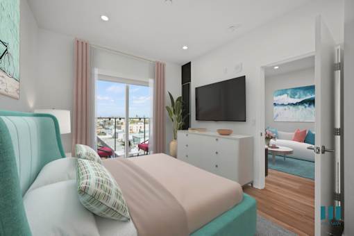 A bedroom with a large bed and a flat screen TV mounted on the wall.