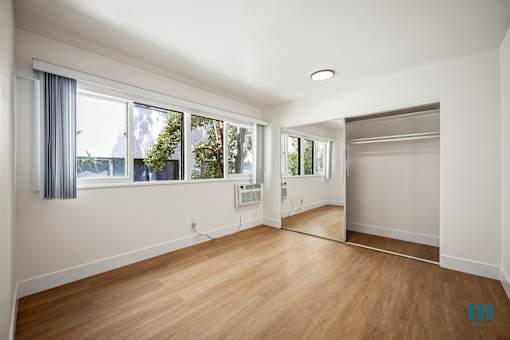 Bedroom with Vinyl Flooring and Lots of Windows and Natural Light