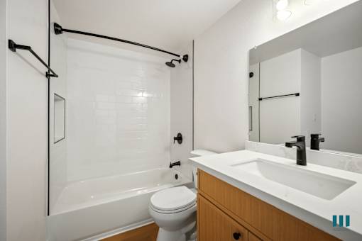 Bathroom with a Shower Bath and Vanity Cabinet Storage