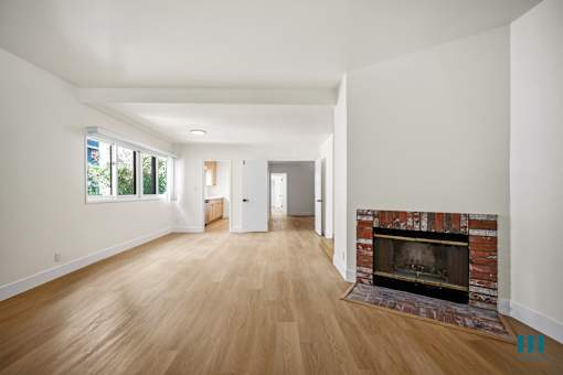 Large-Size Living Room with a Fireplace, Multiple Windows, and Vinyl Flooring