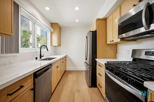 Kitchen with Stainless-Steel Refrigerator, Stove, Dishwasher, and Microwave Oven