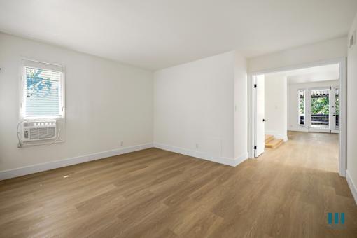Spacious Bedroom with Double Doors and Vinyl Flooring