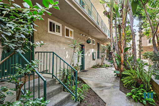 A building with a green railing and steps leading up to it.