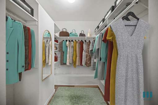 A walk in closet with a green rug and clothes hanging on racks.