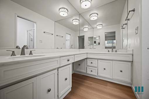 A bathroom with a large mirror and a sink.