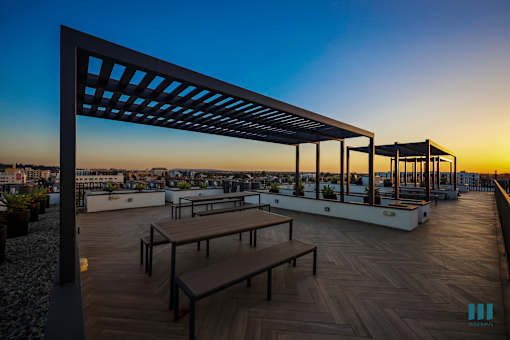 Entertainment Area with Pergola and Sunset Views from the Rooftop Deck