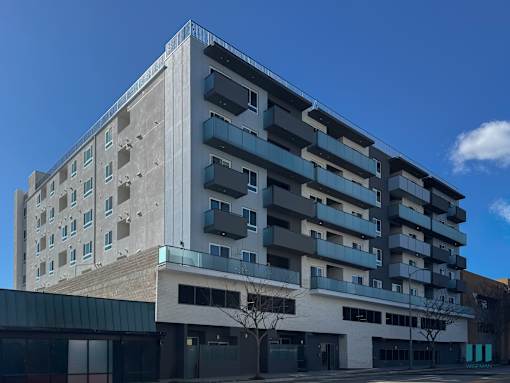A modern building with a mix of concrete and glass facade.