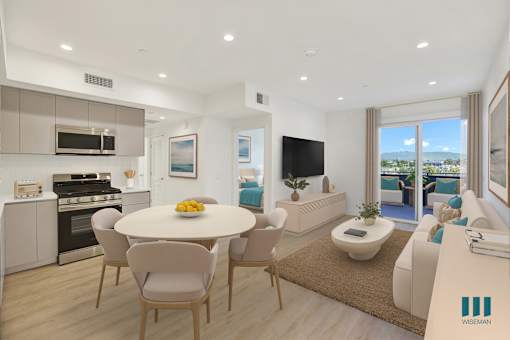 A modern kitchen with a dining table and chairs.