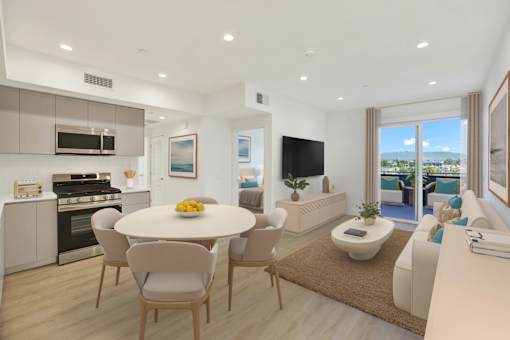 A modern kitchen with a dining table and chairs.